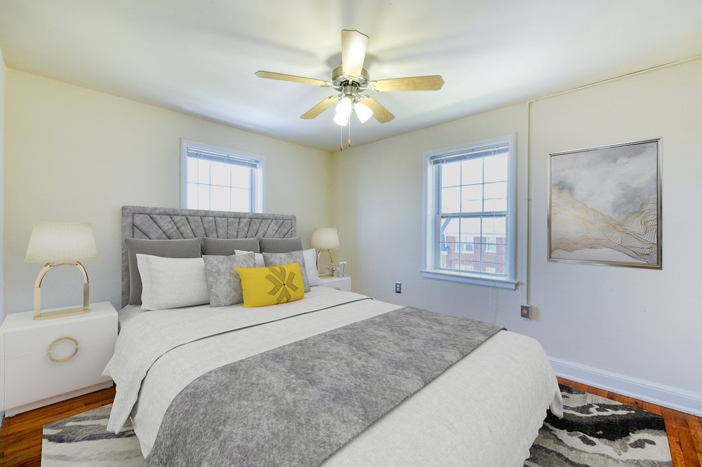 Bedroom with ceiling fan and natural light