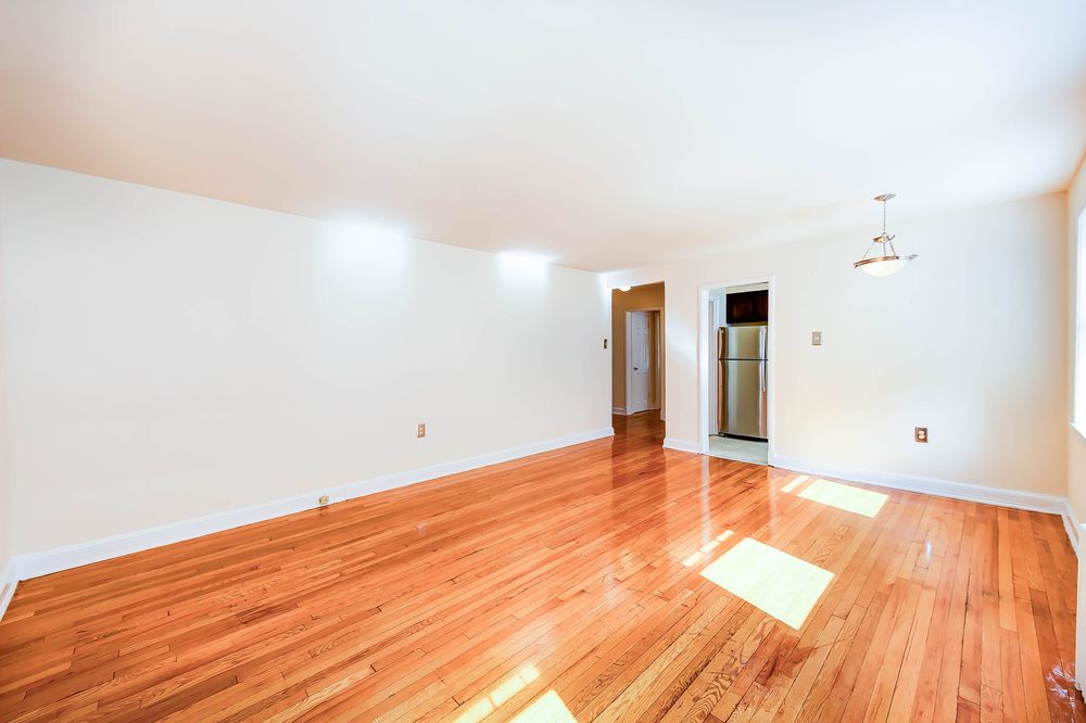 Open living room with hardwood floors and natural light